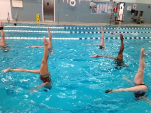 The New Canaan YMCA synchronized swimming team